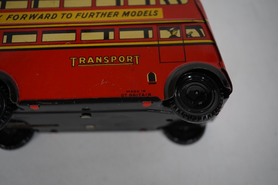 A boxed Wells Brimtoy tinplate clockwork trolley bus loosely in London Transport livery, together with three keys. Condition fair to good, clockwork motor appears to work correctly although has lost grip on the driving a